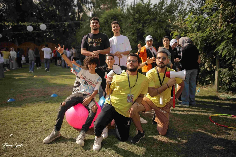 AST crew in yellow shirts with megaphones at an event